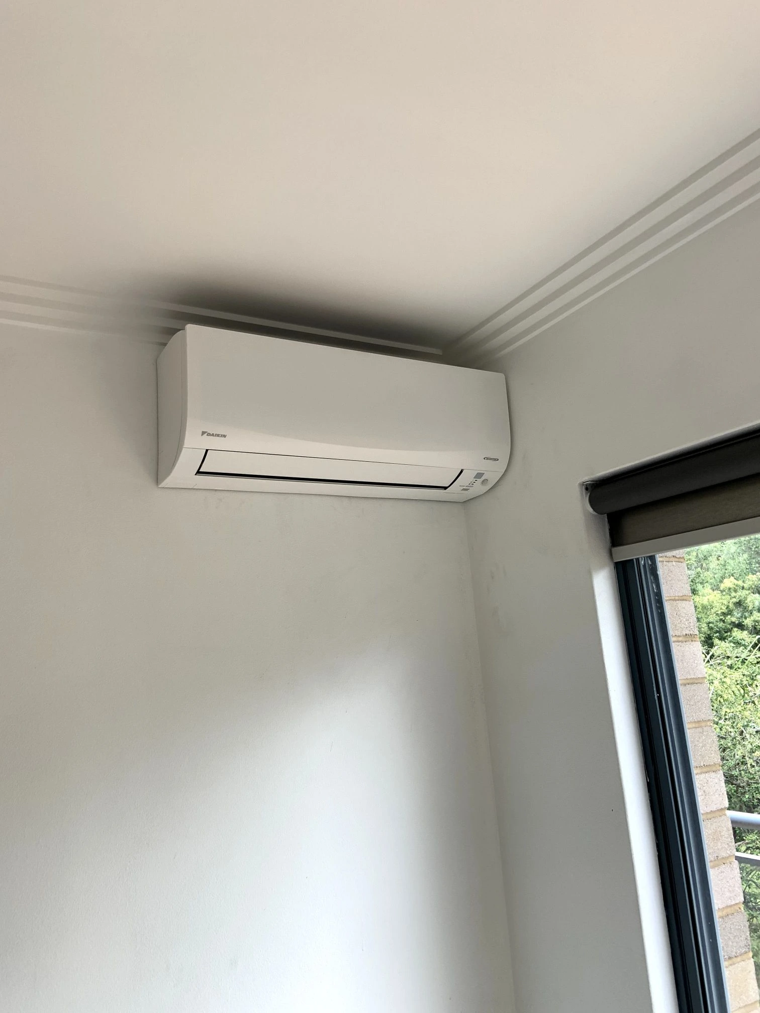 Wall-mounted split system above a doorway