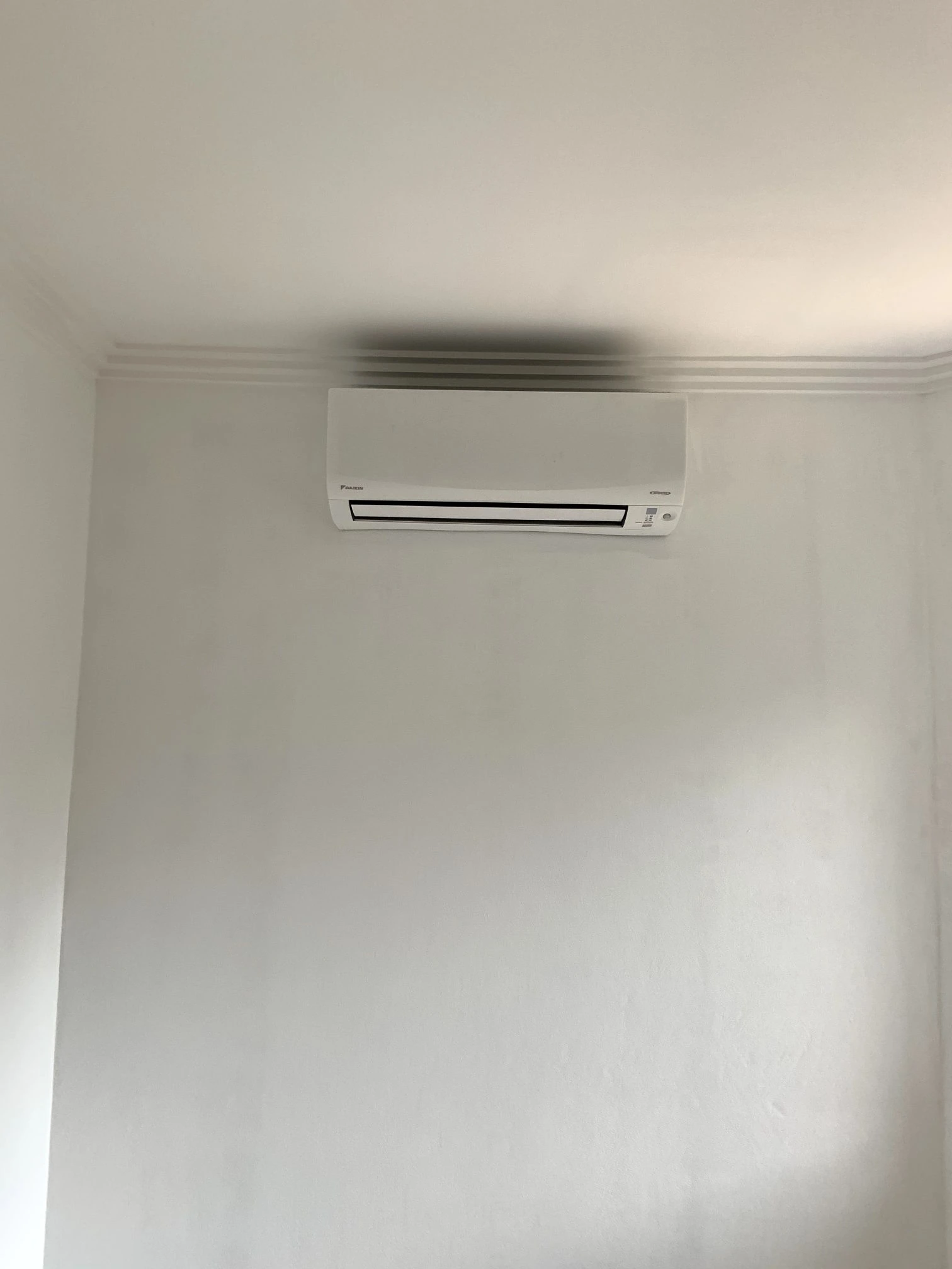 Indoor split system mounted high on a white wall